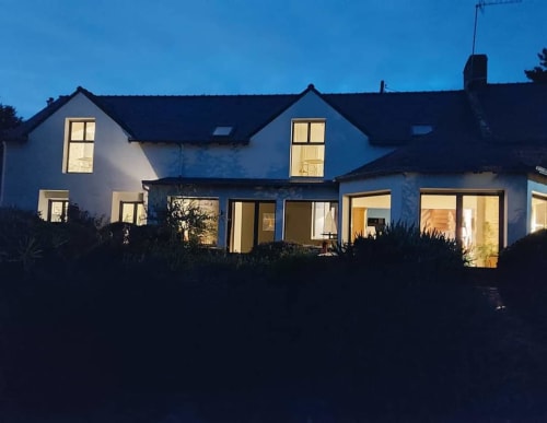 Vue nocturne de Ty Coz Breizh, chambres d'hôtes à Lorient, Bretagne Sud. La maison est illuminée, créant une ambiance chaleureuse et accueillante sous le ciel étoilé, offrant un cadre paisible et apaisant pour les invités.