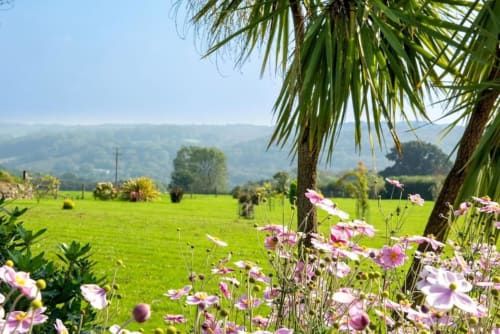 Experience luxury in this holiday home near Tavistock with 1 living room, 1 bedroom, and a walk-in shower. Fully equipped kitchen, terrace with garden views, flat-screen TV, and more amenities. Max occupancy: 4.