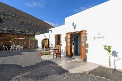 Finca de La Geria whitewashed building with wooden doors and terrace in Yaiza, Lanzarote