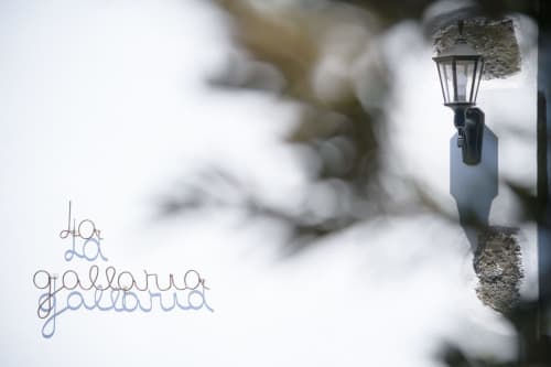 Frost-covered outdoor wall sconce at Finca de La Geria hotel in Yaiza, Spain, with snowy winter backdrop