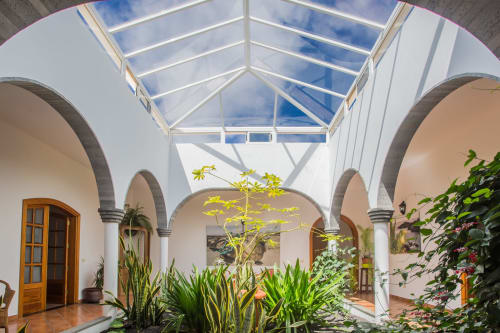 Finca de La Geria courtyard with arched columns, skylight, and tropical plants in Yaiza
