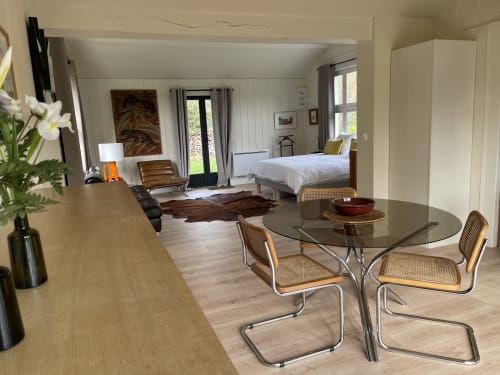 Modern cottage bedroom at Clairseine B&B with dining area, garden views, and contemporary furnishings