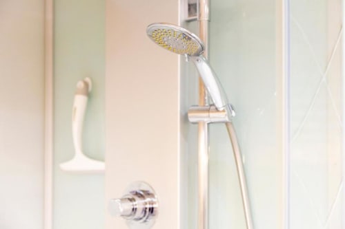 Modern rainfall showerhead with handheld spray in Les logis de Kergoulou's Madame de la Fayette room, Concarneau