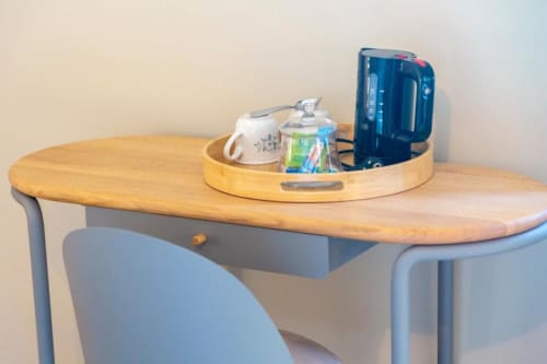 Wooden desk with blue chair in Anne de Bretagne suite at Les logis de Kergoulou BnB, Concarneau, with beverage station