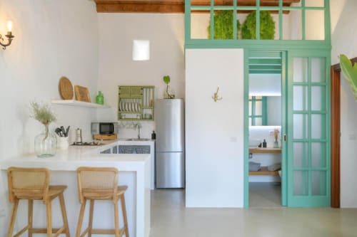 Modern kitchen and living area in La Era cottage at Finca de La Geria, Yaiza, with mint green doors, white cabinetry, and