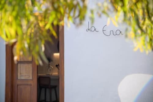La Era cottage room entrance at Finca de La Geria with garden view and hanging willow branches framing the doorway