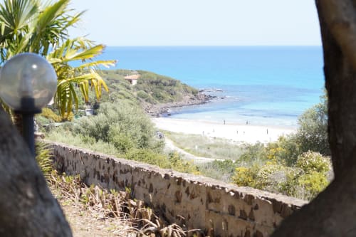Scenic sea view from Cottage Fuile Mare villa in Orosei, showing pristine beach and coastline with Mediterranean vegetation