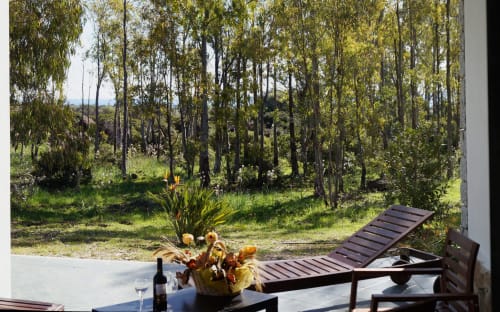 Tuscan villa veranda with wooden loungers overlooking eucalyptus forest near Orosei, Italy