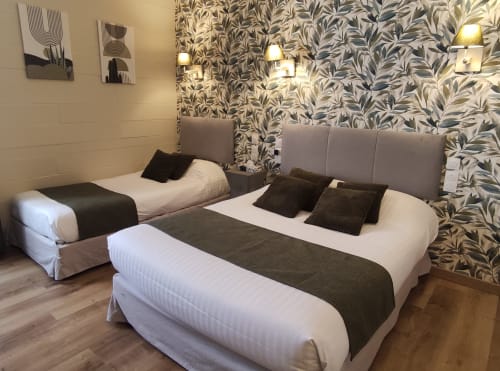 Triple standard room at Le Pavillon Saint Martin Hotel in Souillac with two queen beds, leafy wallpaper, and modern amenities
