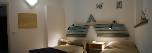 Modern bedroom with twin beds, wooden headboards, and contemporary wall lighting at Sa Domo De Mannoi in Orosei