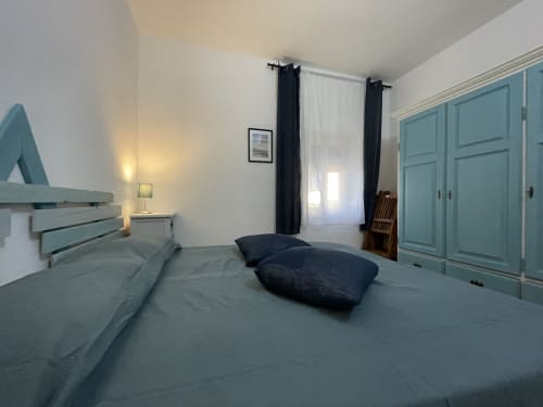 Spacious bedroom at Sa Domo De Mannoi apartment in Orosei with turquoise wardrobes, twin beds, and modern amenities