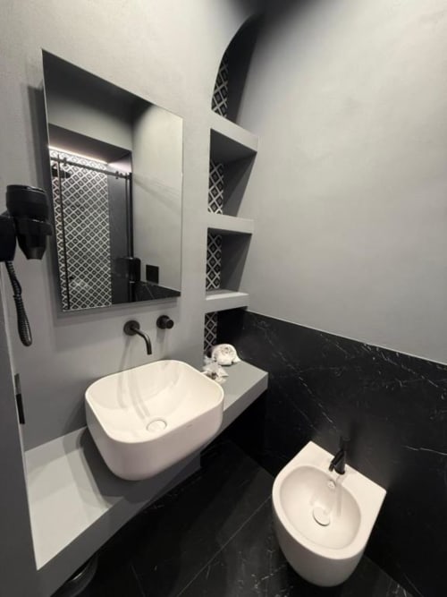 Bagno moderno bianco e nero a Volta 70 Napoli con doppi lavabi, specchio con ripiani e bidet