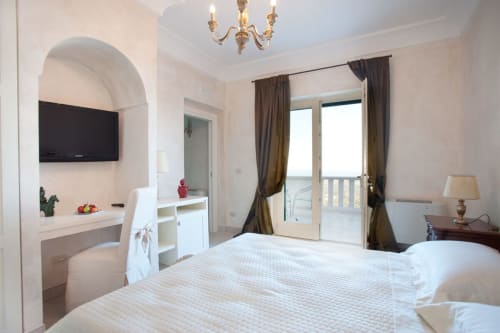 Luxury suite at Al Mirador Resort in Fasano with sea view balcony, flat-screen TV, and modern amenities