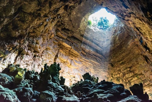Sunlit cave interior with rocky formations near Al Mirador Resort in Fasano, Italy