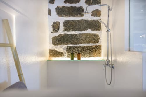 Modern bathroom shower with rustic stone wall backdrop at Finca de La Geria cottage in Yaiza