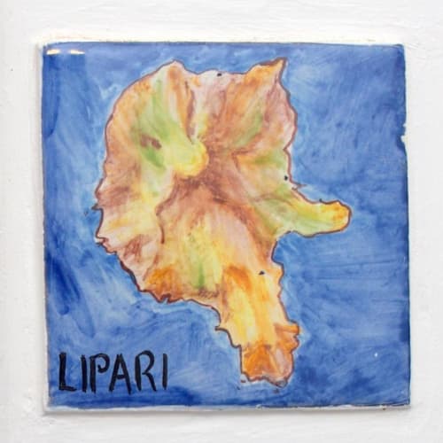 Decorative tile map of Lipari island with warm earth tones on blue background at Hotel Principe di Rinella, Sicily