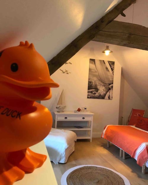 Chambre spacieuse aux couleurs nautiques au Clos Mahiel. Ambiance chaleureuse sous poutres de charpente apparentes.