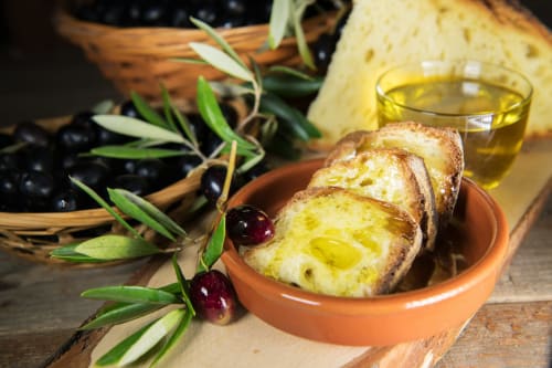 Sliced bread with olive oil, fresh olives and rosemary at Al Mirador Resort in Fasano, Italy