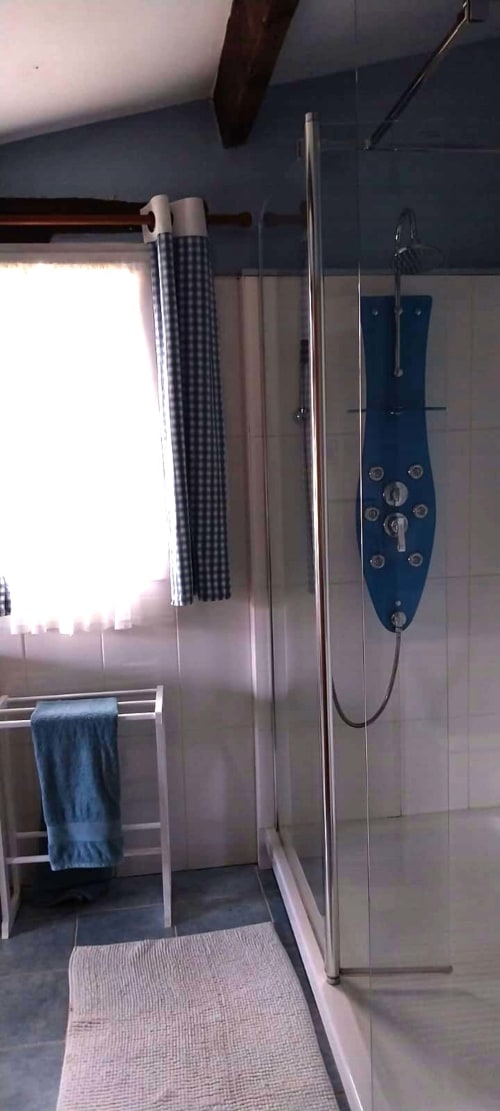 Modern shower enclosure with blue digital panel in Le Séchoir cottage bathroom at La Barrat, Monmarvès