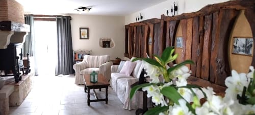 La Crèche cottage at La Barrat B&B in Monmarvès with rustic wooden doors, comfortable seating, and white flowers in