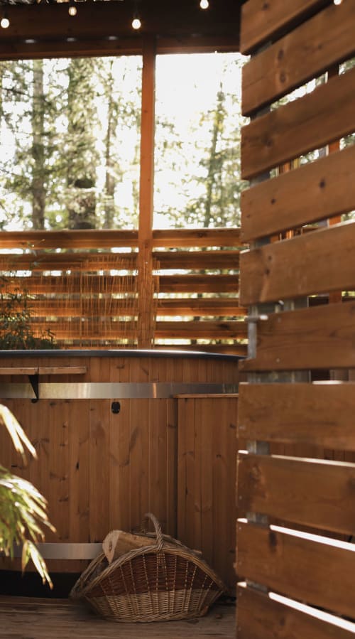 Intimate wooden terrace with slatted screens and plants