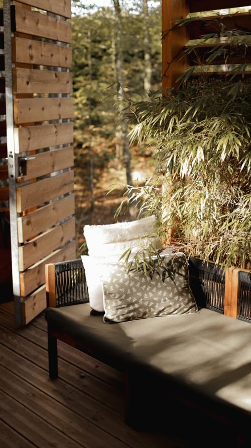 Wooden terrace lounge corner with plants and chair