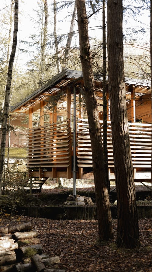 Stilt lodge façade among the trees