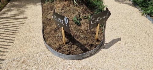 Garden planter with handwritten plant markers at Domaine de la Grande Décision cottage in La Douze