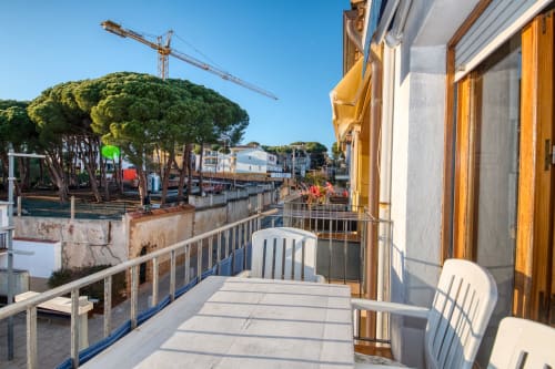 Balcony view of Calella de Palafrugell with waterfront, boats, and Mediterranean architecture