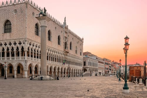 Doge's Palace at sunrise in Venice, near Palazzo San Firmino Residenza D'Epoca with ornate architecture and waterfront views