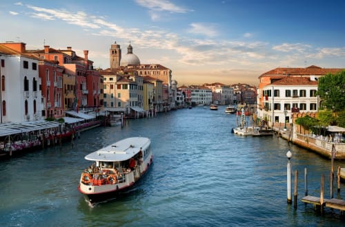 Grand Canal Venice with colorful buildings and vaporetto boat near Palazzo San Firmino