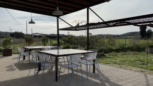 Outdoor dining terrace at Finques Garcia Enrich in Palafrugell with tables, chairs, and rural countryside views