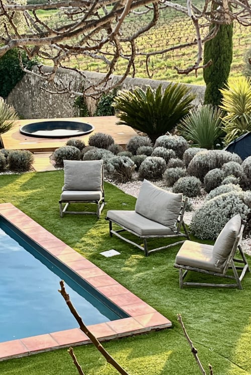 Saint Martin B&B lounge chairs by pool with olive trees and vineyard views in Ollioules, France