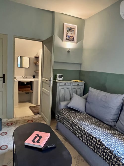 Saint Martin BnB bedroom in Ollioules with bed, ensuite bathroom, and sage green accent wall