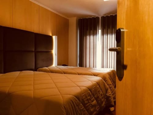 Bed of Triple Room with Balcony at Hotel Europa
