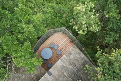 Aerial view of La Pinede villa at Cabanes et lodges du Belvédère with wooden terrace, spa pools, surrounded by forest