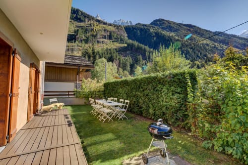 Outside with place to relax, grill area, and a mountain view | Terrace Apartment – ​​Elegance and Comfort at the Foot of Mont Blanc