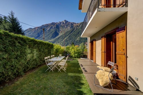 Outside with place to relax, grill area, and a mountain view | Terrace Apartment – ​​Elegance and Comfort at the Foot of Mont Blanc