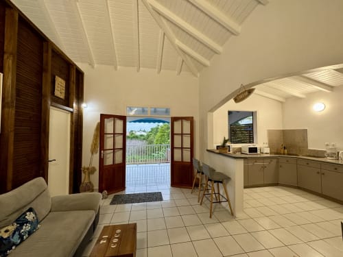 Séjour avec cuisine et vue sur l'extérieur | Ti-Coco Lodge – Locations de vacances authentiques en Guadeloupe
