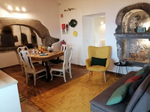 Dining area with sofa | Delight in the Charm of Ti Chôa - Casa do Biscoitinho