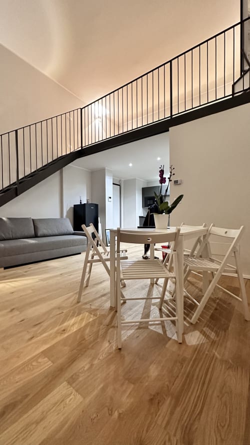 Loft moderno a Pellicceria Superior a Genova con zona pranzo, pavimenti in legno e soppalco