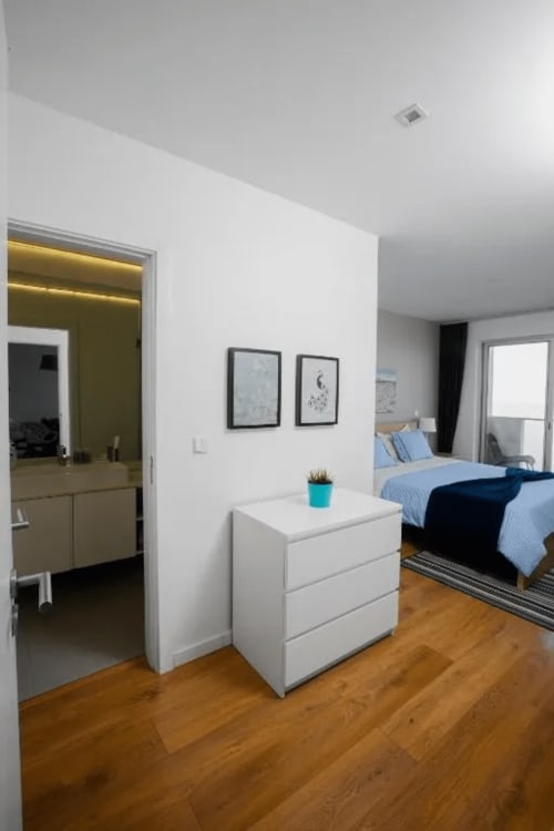 Bedroom and bathroom with drawer | Unwind in Our Stunning Apartment with Breathtaking Sea Views