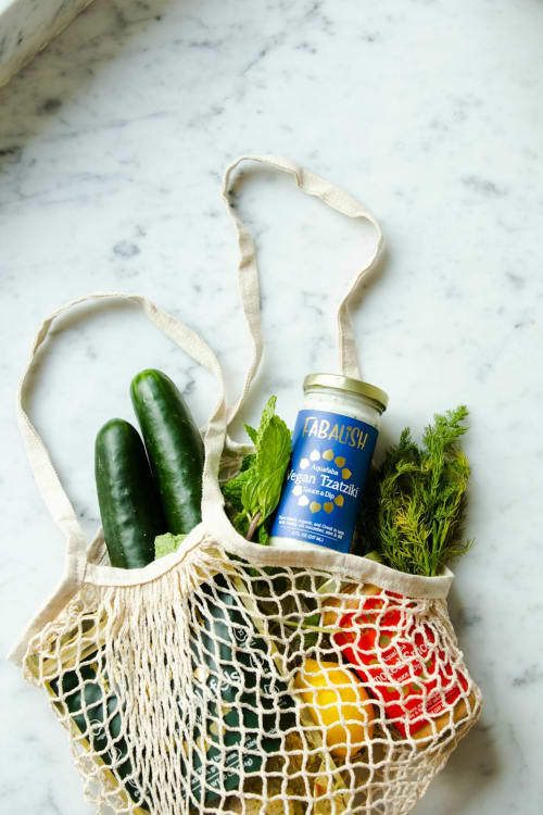 Reusable mesh bag with fresh cucumbers, herbs, and Abaitsh tzatziki dip at La Maison D'ambrine, Chamaret France