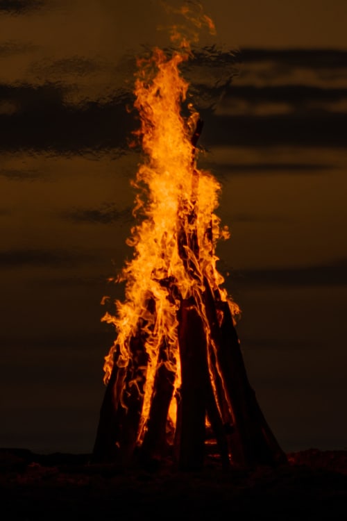 Bonfire flames rising at night, Organica Yoga Shelter in Paquera, Costa Rica