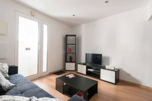 Living area with television, sofa and a view | Modern Comfort in the Bustling City Center