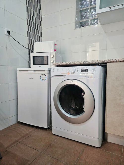 Washing machine, oven, and refrigerator | Modern Comfort in the Bustling City Center