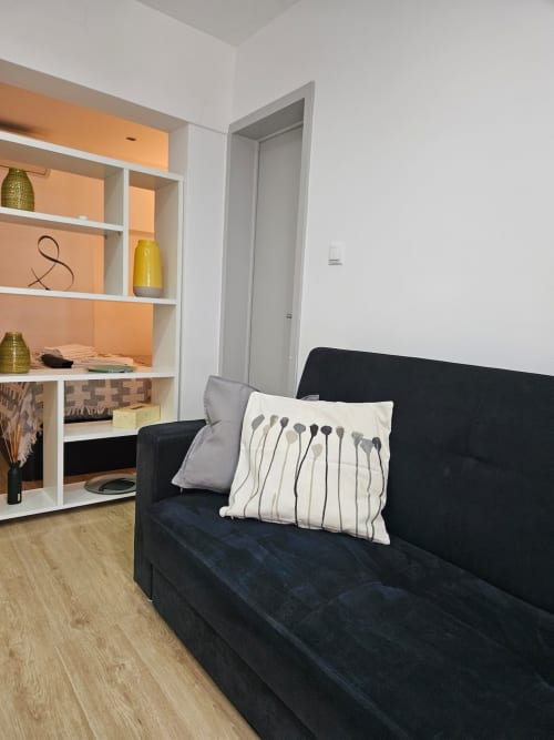 Comfortable sofa and pillows | Modern Comfort in the Bustling City Center