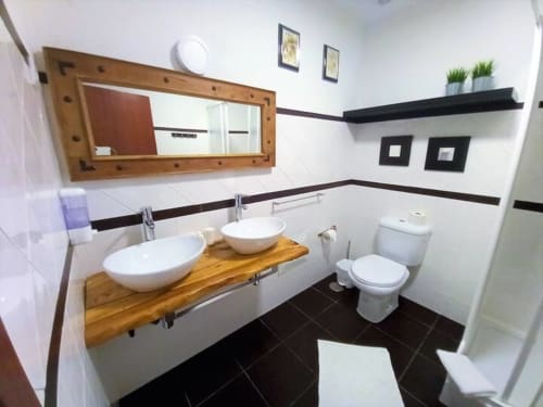 Bathroom with two sink, mirror, and toilet | Casa da Pedrosa: Your Ideal Retreat in Ponte de Lima, Portugal