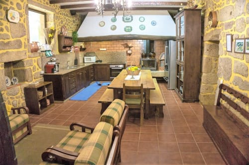 Spacious living area, dining area and kitchen of the house | Casa da Pedrosa: Your Ideal Retreat in Ponte de Lima, Portugal