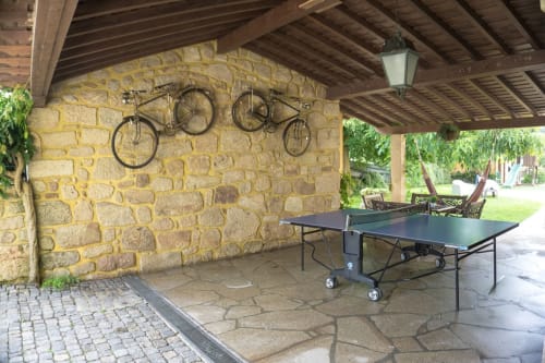 Table tennis and two bikes outside the house | Casa da Pedrosa: Your Ideal Retreat in Ponte de Lima, Portugal